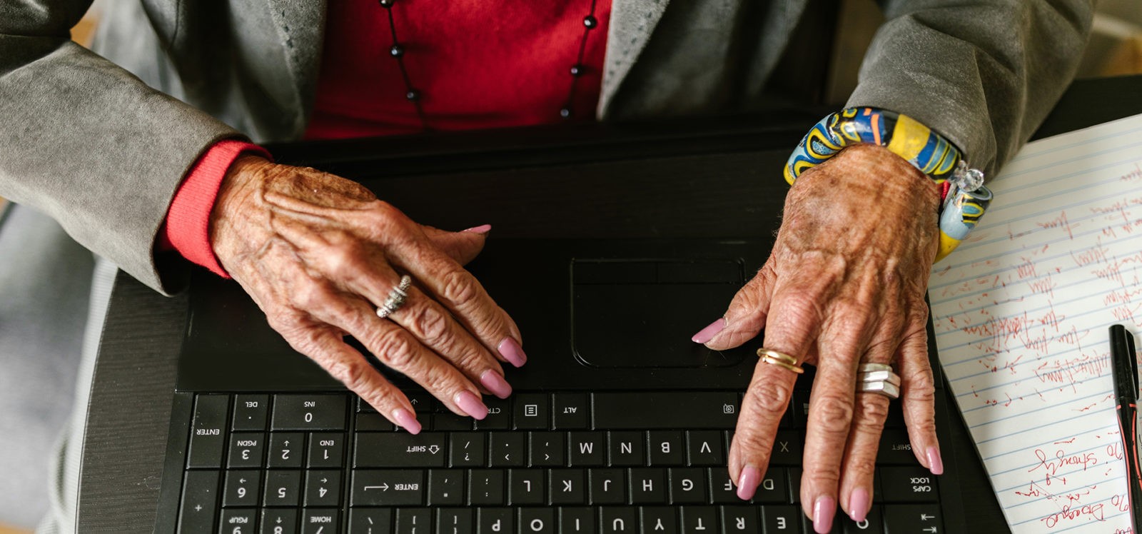 older woman typing on laptop